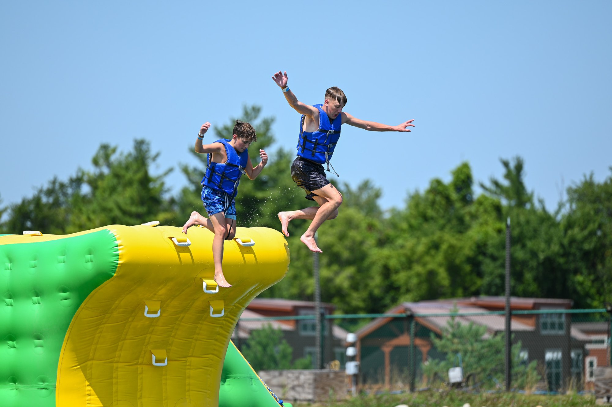 An image of two Jellystone campers jumping off of Adventure Island.