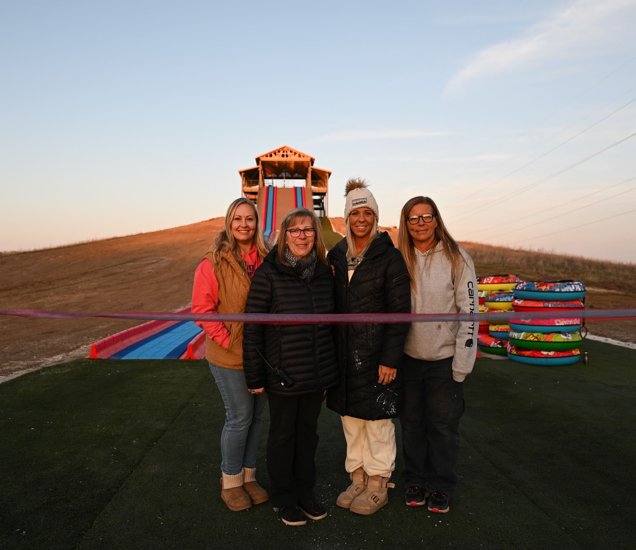Shareholders stand in front of Randy's Thrill Hill at the grand opening of the super mega slide at Bear Paw Adventure Park.