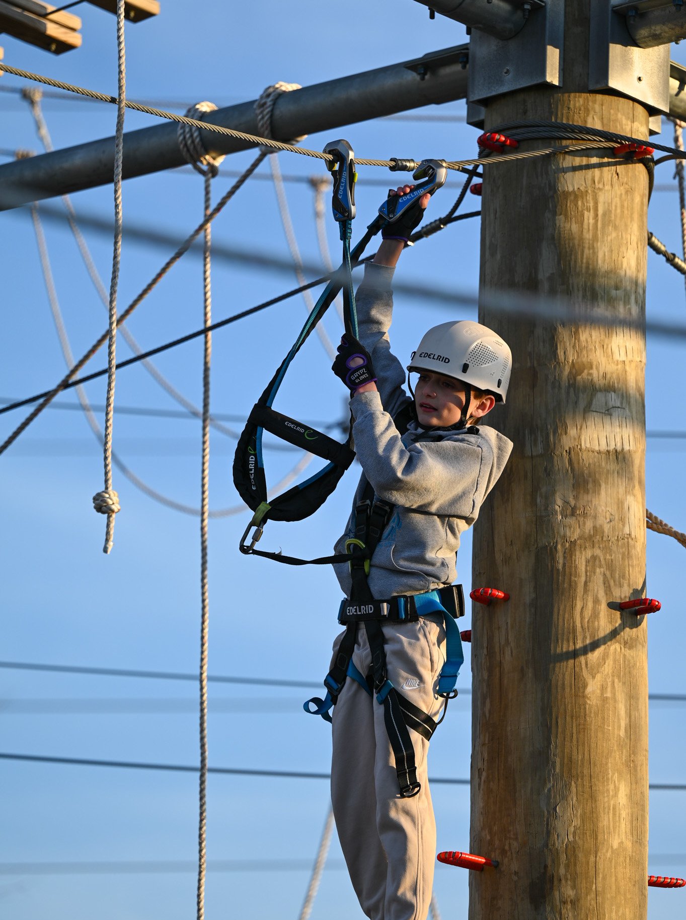 A Jellystone Park camper having fun on the ropes course.