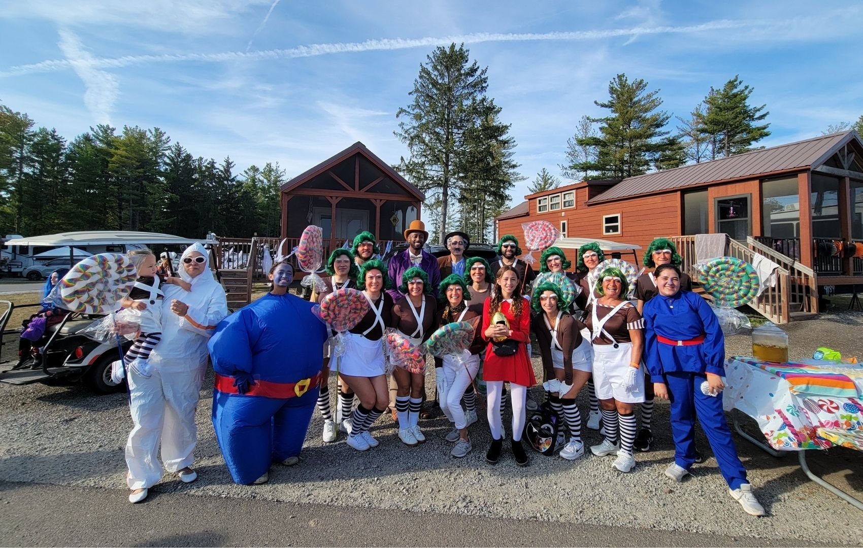 An image of a bunch of Jellystone campers having fun in their costumes at the park.