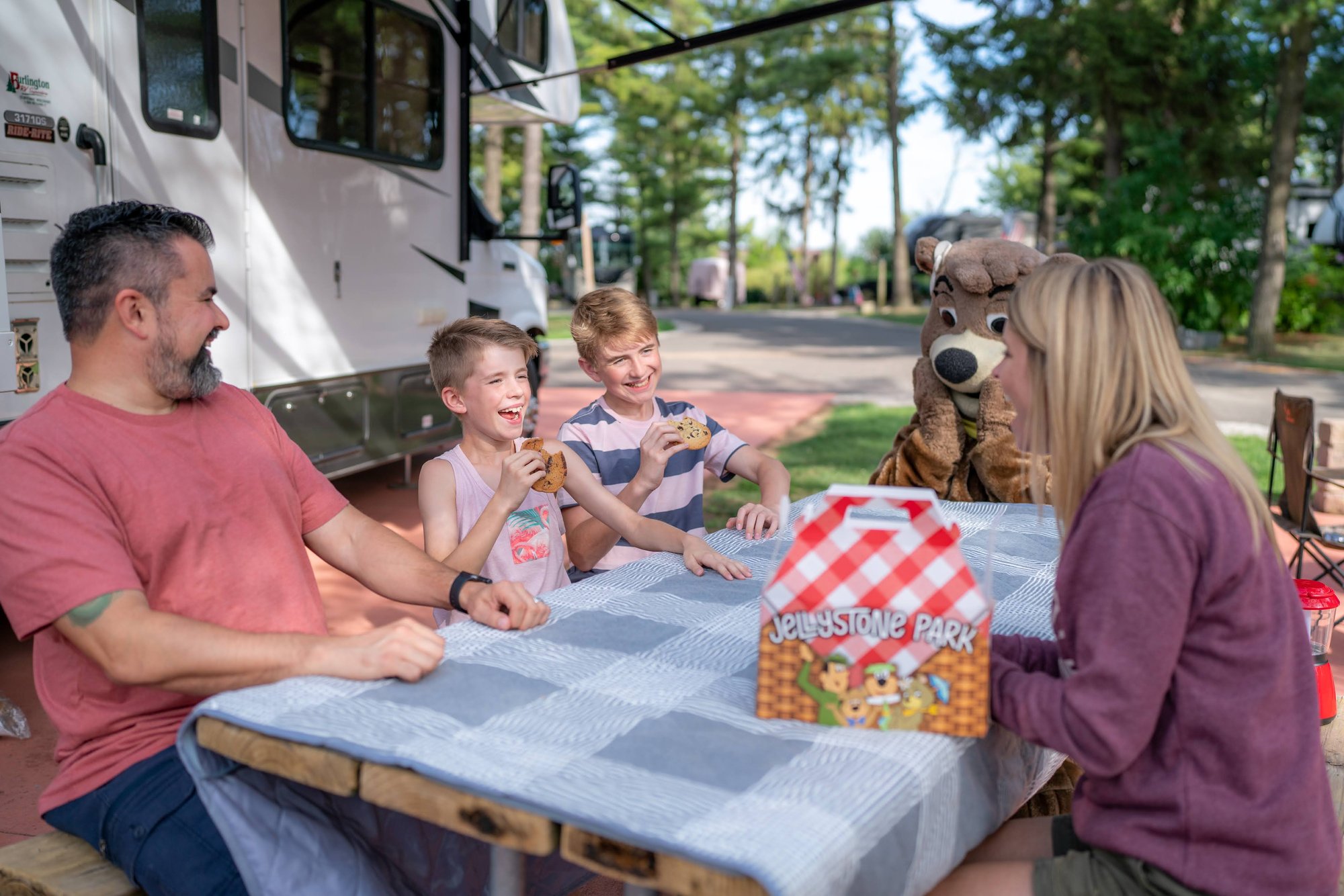 An image of a family having fun with their pet at Jellystone Park.