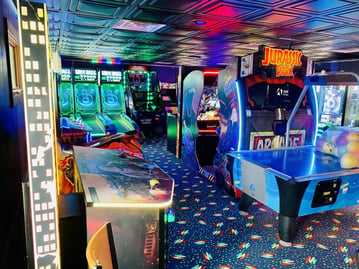 An image of kids playing games in the Arcade at Jellystone Park™ Caledonia. An image of kids playing games in the Arcade at Jellystone Park™ Caledonia.