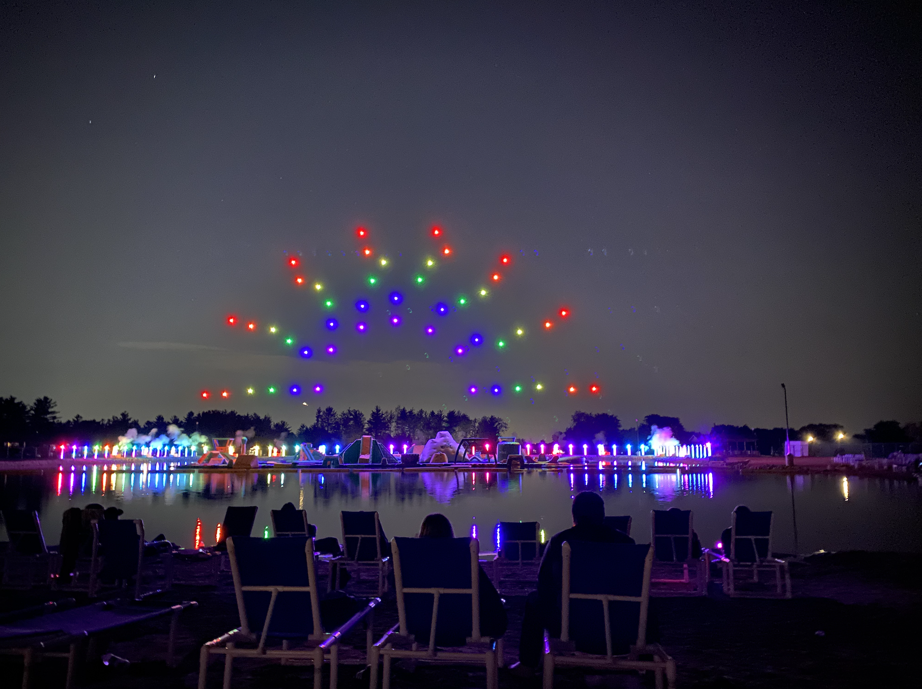 Rainbow drone design flies in the sky during the drone show at Bear Paw Nights.