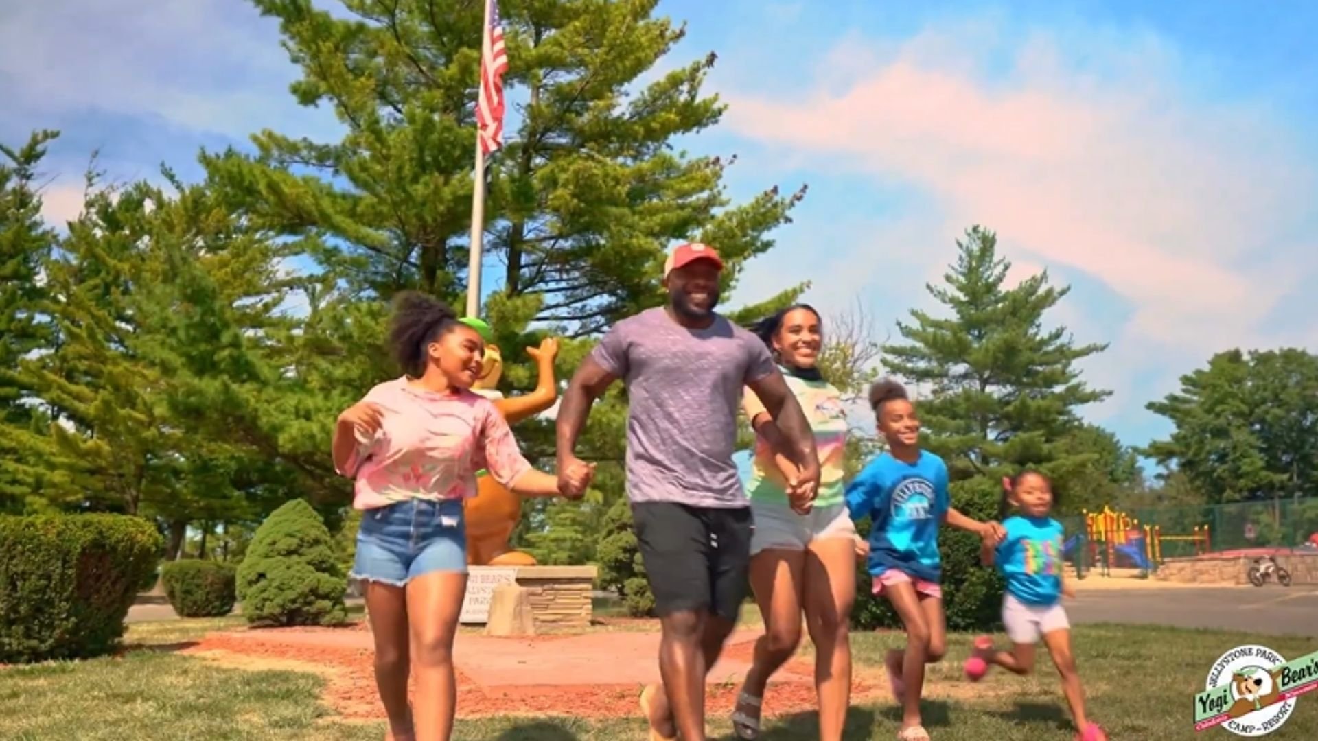 An image of a family happily walking into Jellystone Park.