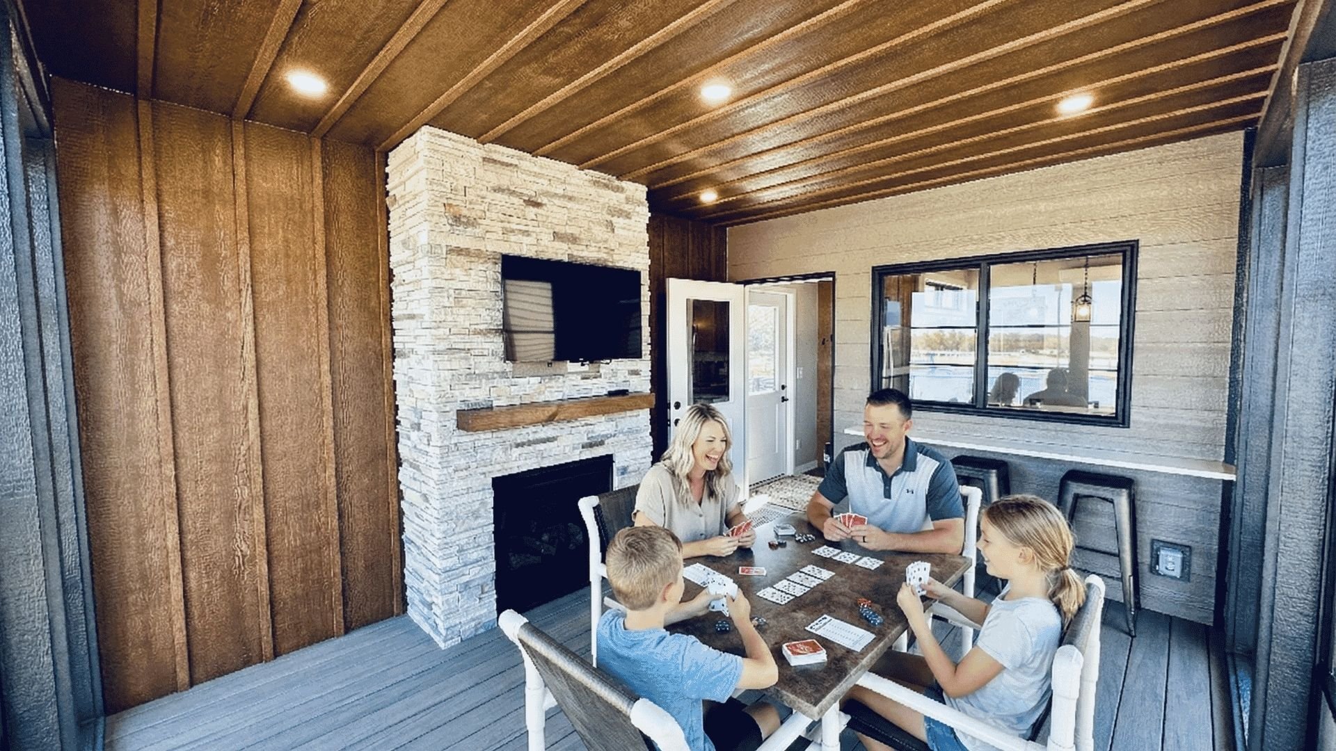 An image of a family playing cards while glamping in their Skydeck.