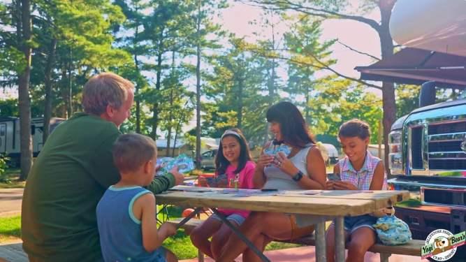An image of a family camping at Jellystone Park. An image of a family camping at Jellystone Park.