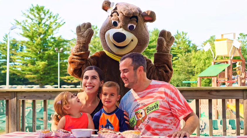 An image of a family at their cabin at Jellystone Park with Cindy Bear. An image of a family at their cabin at Jellystone Park with Cindy Bear.