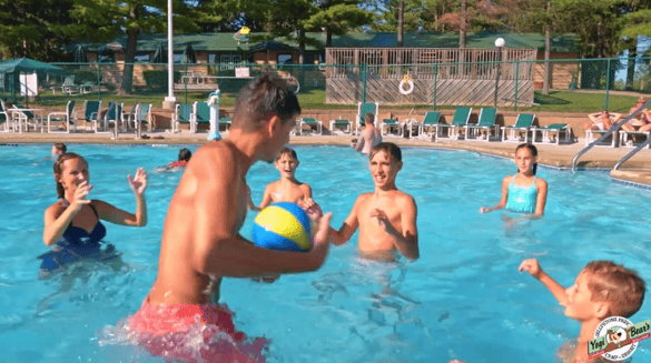 An image of kids playing in a pool at Jellystone Park.
