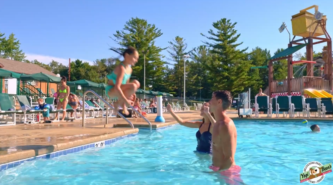 An image of a family of Jellystone campers having fun at the pool.
