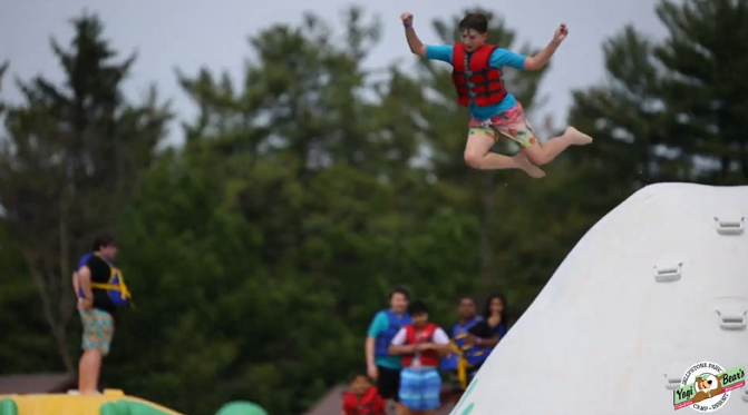 An image taken of Jellystone campers having a good time on the Wibit at Bear Paw Beach.