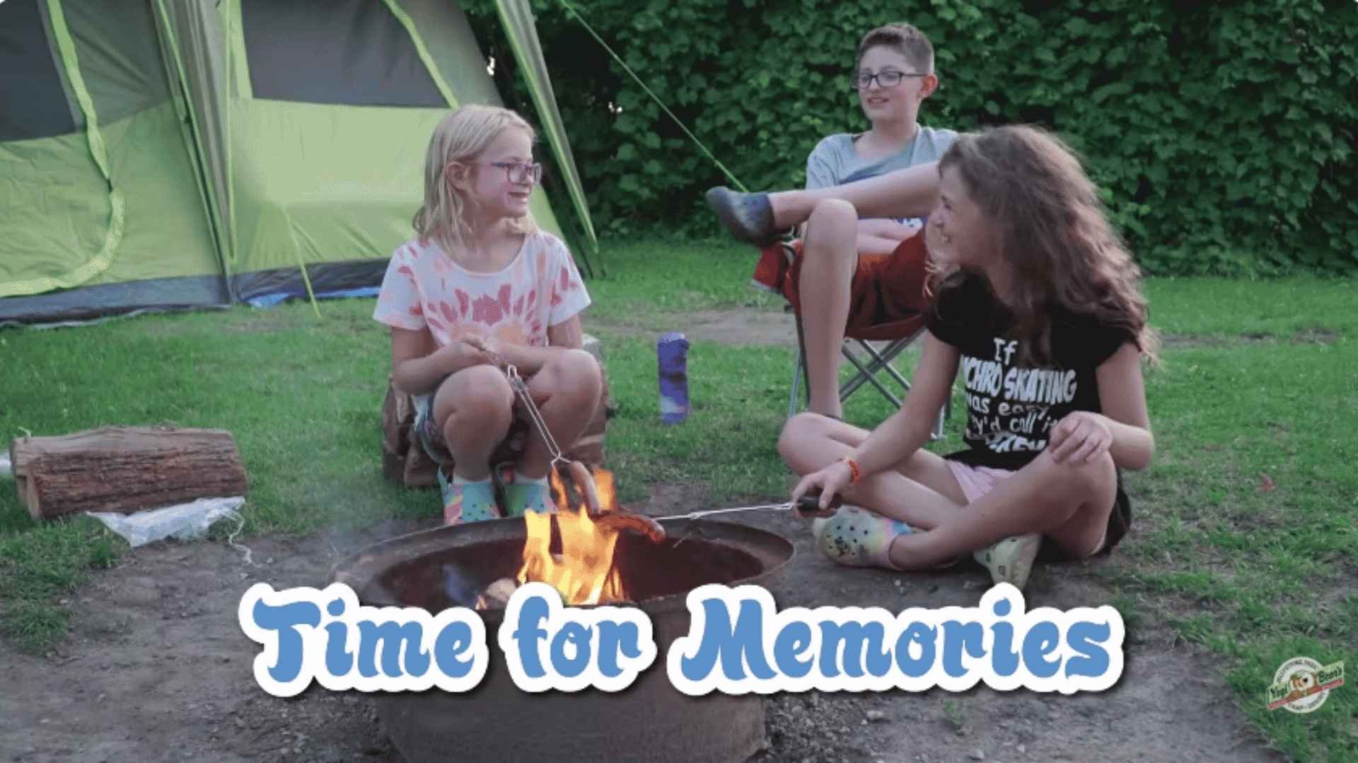 An image of 3 Jellystone Park campers having fun at their tent site.