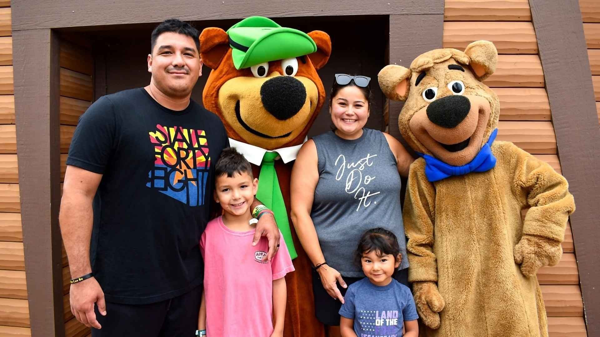 An image of a family having fun with Yogi and Boo Boo at the Ranger Station.