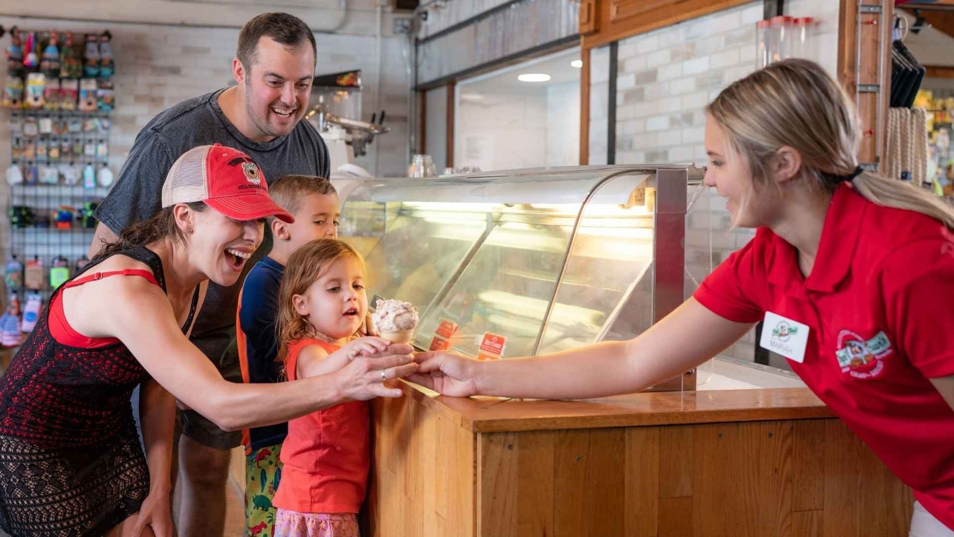 An image of a family of Jellystone campers getting ice cream.