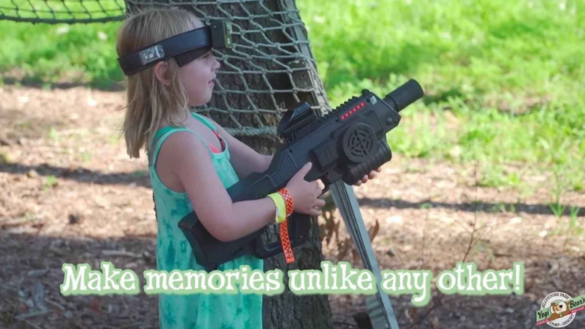 An image of a camper playing laser tag at Jellystone Park.